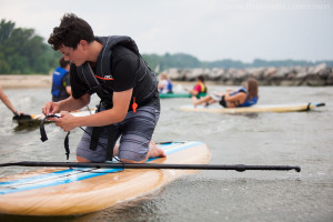 Carter Herman adjusts the ankle strap on his paddleboard at the York River in Yorktown, Va., on Thursday, July 2, 2015. In addition to kayaks and paddleboards, Patriot Tours and Provisions rents canoes, bikes, and Segways.